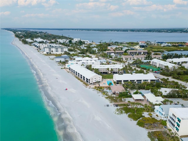 bird's eye view with a water view and a beach view