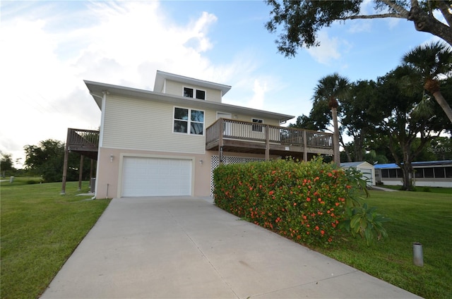 view of front facade featuring a wooden deck, a front lawn, and a garage