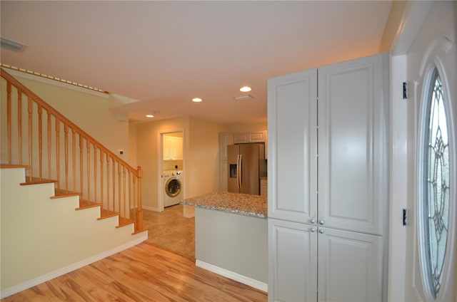 entrance foyer featuring washer / clothes dryer and light hardwood / wood-style floors