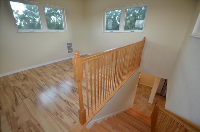 stairs featuring hardwood / wood-style flooring