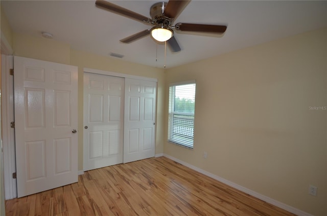 unfurnished bedroom featuring ceiling fan, a closet, and light hardwood / wood-style floors