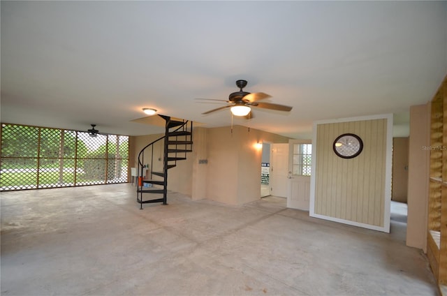 interior space with ceiling fan