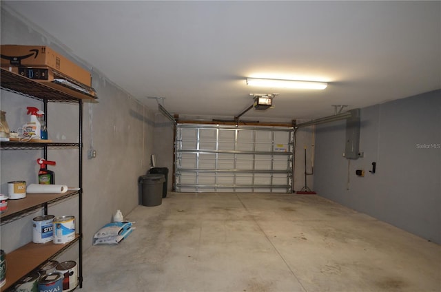 garage with electric panel and a garage door opener