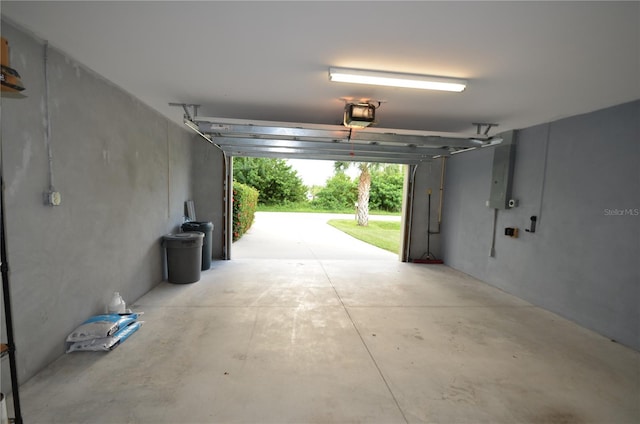 garage with a garage door opener and electric panel