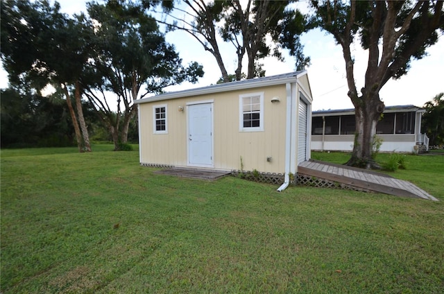 view of outbuilding featuring a yard