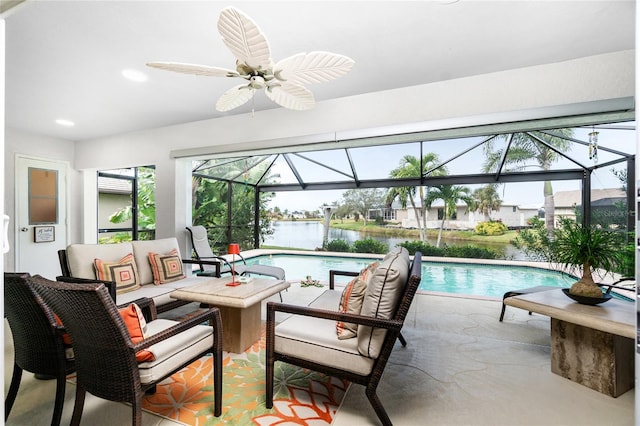 interior space with ceiling fan, a pool, and a water view