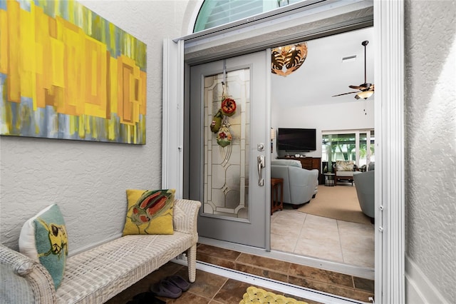 exterior space featuring tile patterned flooring and ceiling fan