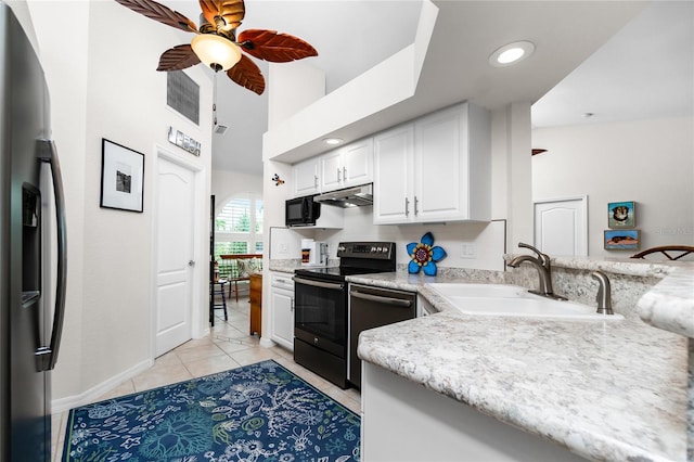 kitchen with appliances with stainless steel finishes, light tile patterned flooring, white cabinetry, ceiling fan, and sink