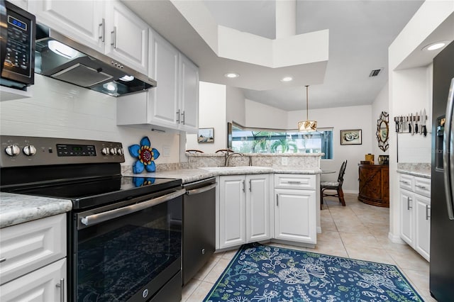 kitchen with appliances with stainless steel finishes, light tile patterned floors, and white cabinetry