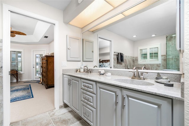 bathroom featuring a shower, vanity, and ceiling fan