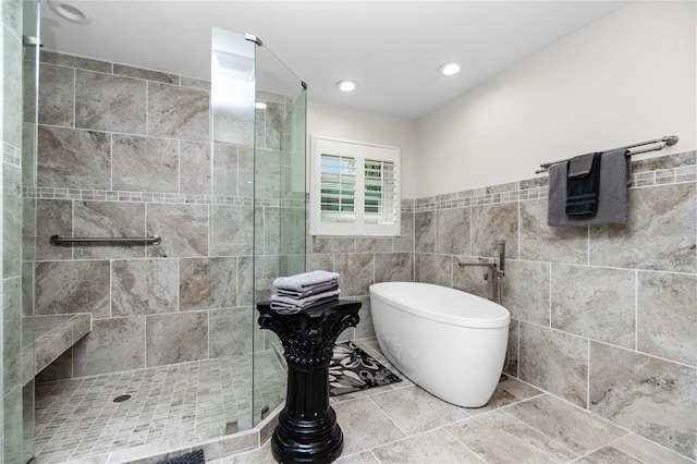 bathroom with plus walk in shower and tile walls