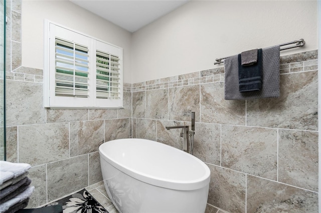 bathroom with tile walls and a bath