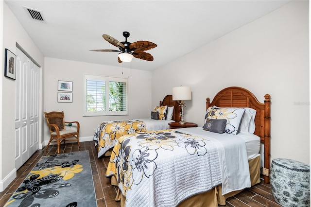 bedroom with a closet, dark hardwood / wood-style floors, and ceiling fan