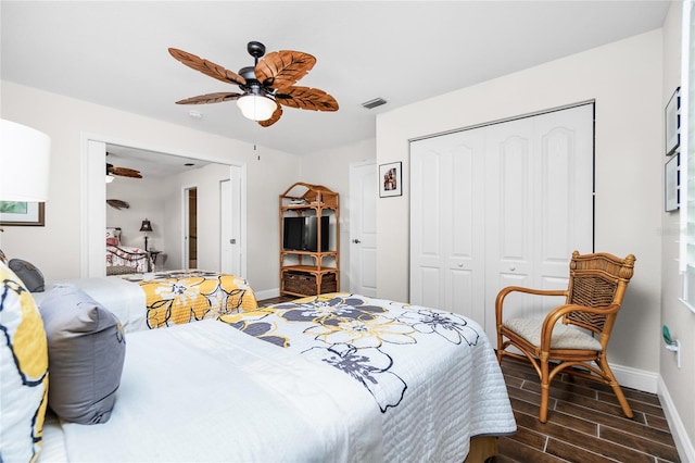 bedroom with ceiling fan, a closet, and dark wood-type flooring