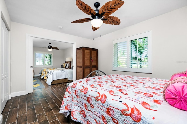 bedroom featuring ceiling fan, dark wood-type flooring, and a closet