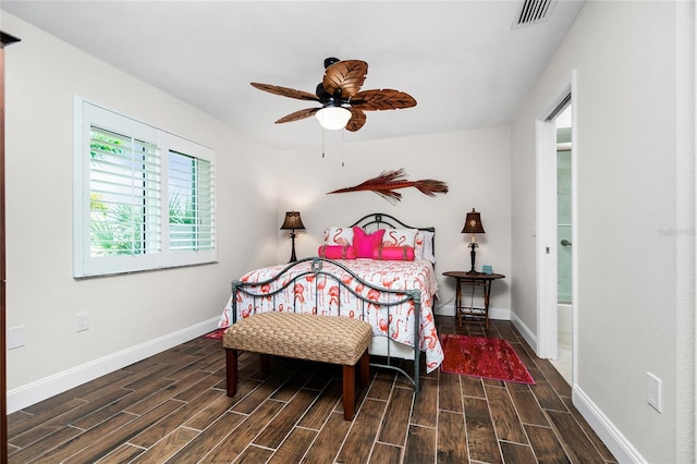 bedroom with dark hardwood / wood-style floors and ceiling fan