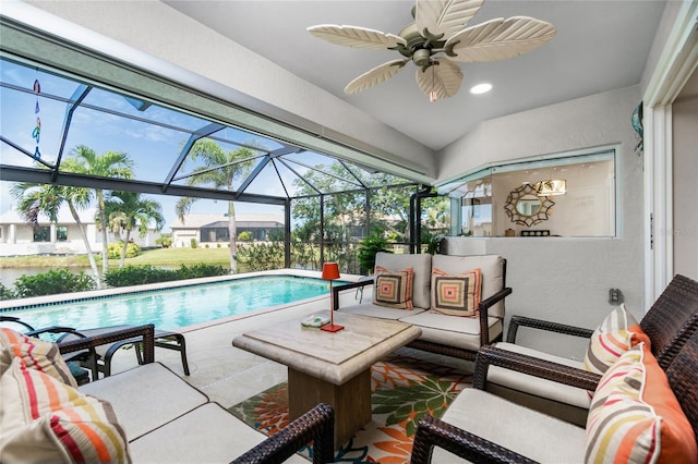 view of swimming pool featuring a lanai, ceiling fan, and a patio area