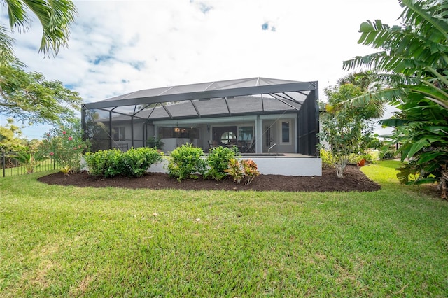 back of property featuring a yard and a lanai