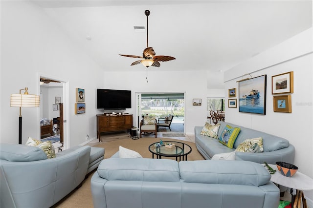 carpeted living room with high vaulted ceiling and ceiling fan