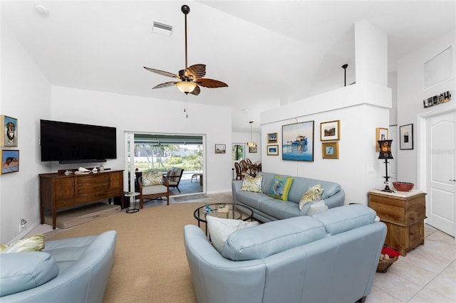 tiled living room featuring a high ceiling and ceiling fan