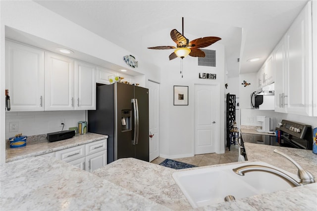 kitchen with light tile patterned flooring, sink, white cabinetry, stainless steel appliances, and ceiling fan