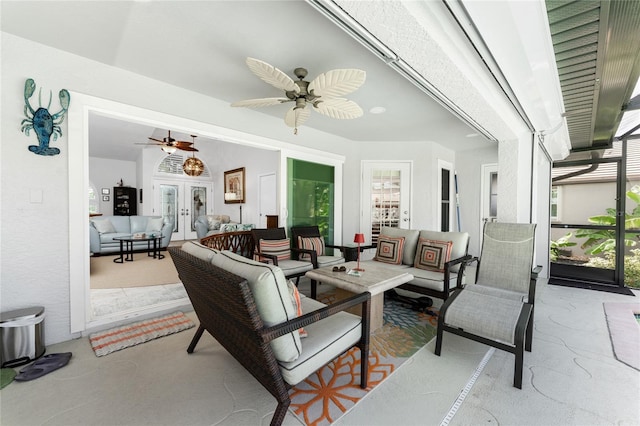 living room with a healthy amount of sunlight, ceiling fan, and french doors