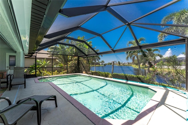 view of pool featuring a patio, a water view, and glass enclosure