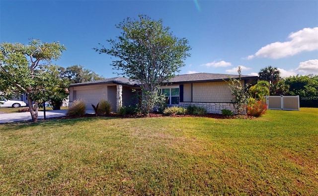 single story home featuring a garage and a front lawn