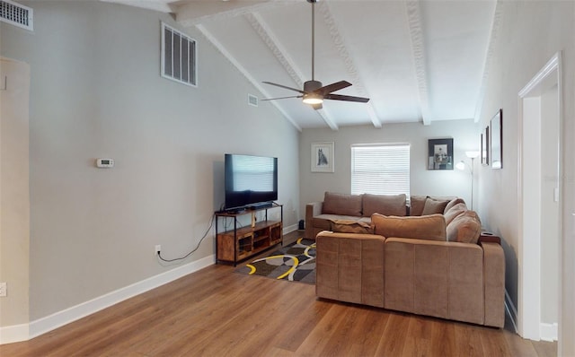 living room with hardwood / wood-style floors, ceiling fan, and vaulted ceiling with beams