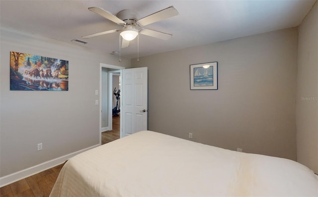 bedroom with hardwood / wood-style floors and ceiling fan