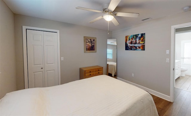 bedroom featuring a closet, ceiling fan, wood-type flooring, and ensuite bath