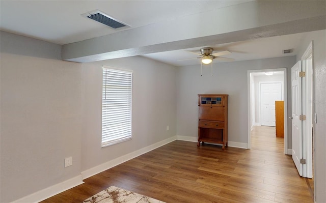 unfurnished room featuring dark hardwood / wood-style flooring and ceiling fan