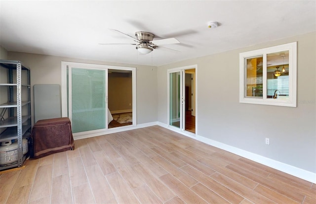 spare room featuring light hardwood / wood-style flooring and ceiling fan