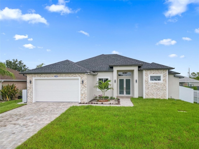 prairie-style home featuring french doors, a garage, and a front yard