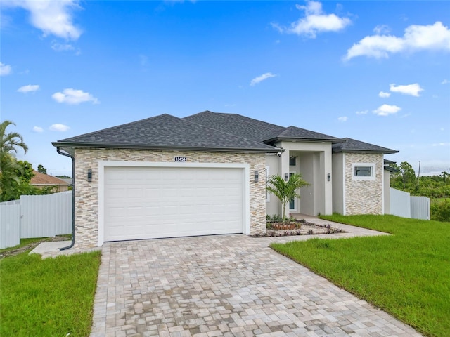 view of front of property featuring a garage and a front lawn