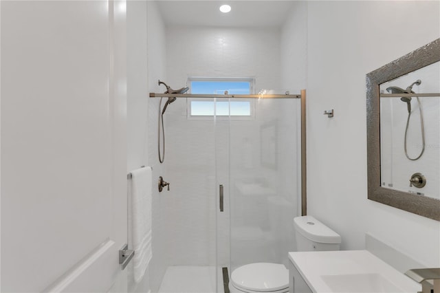 bathroom with vanity, walk in shower, and toilet