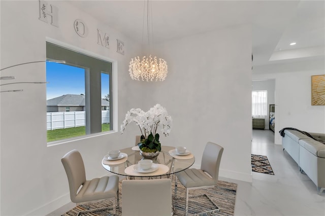 dining area featuring a notable chandelier