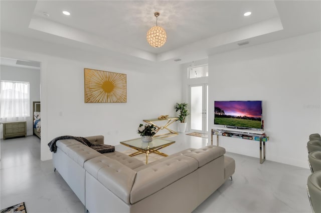 living room featuring a tray ceiling