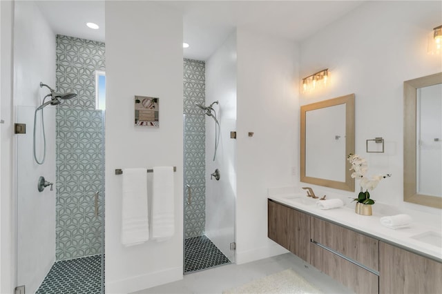 bathroom with tiled shower and vanity