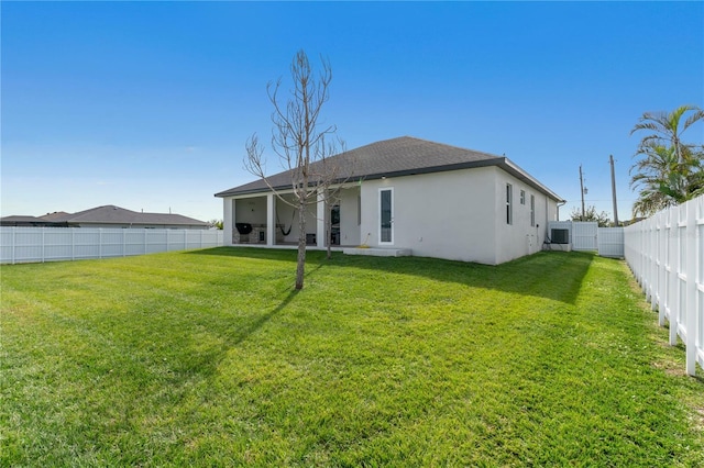 rear view of property with a lawn