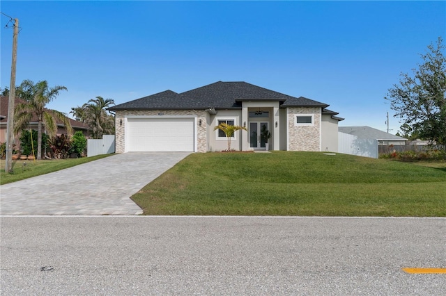 prairie-style home featuring a garage and a front yard