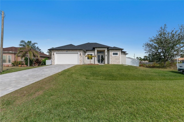 view of front of house featuring a garage and a front lawn