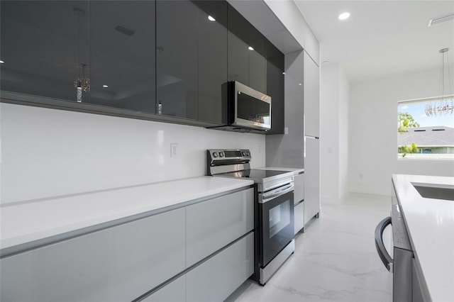 kitchen featuring decorative light fixtures and appliances with stainless steel finishes