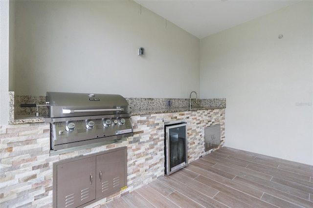 view of patio / terrace featuring area for grilling, sink, beverage cooler, and exterior kitchen