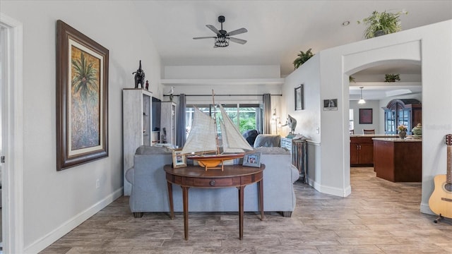 living room featuring wood-type flooring and ceiling fan