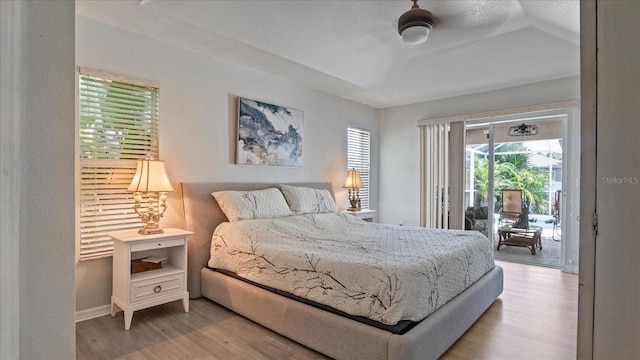 bedroom with light wood-type flooring, ceiling fan, and access to exterior