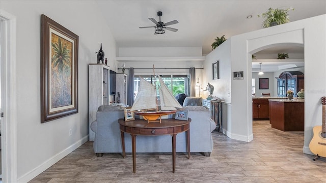 living room featuring hardwood / wood-style floors and ceiling fan