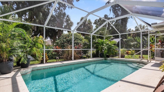 view of pool with glass enclosure