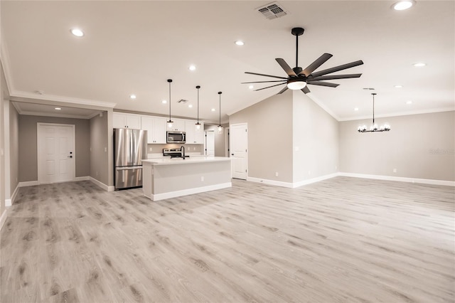 unfurnished living room featuring lofted ceiling, ceiling fan with notable chandelier, ornamental molding, and light hardwood / wood-style flooring