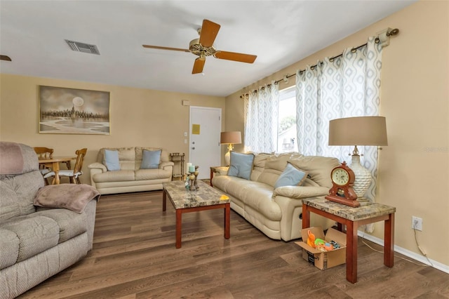 living room featuring ceiling fan and dark hardwood / wood-style flooring